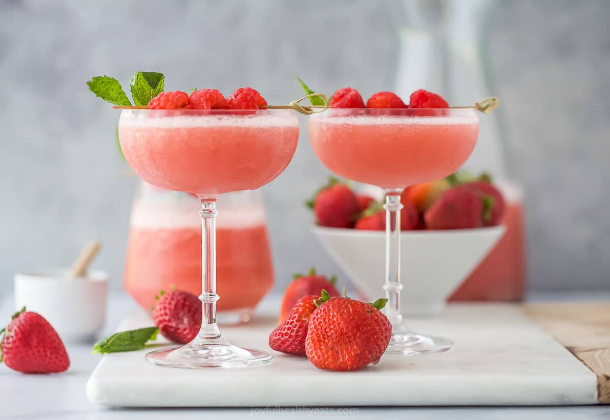 frozen rosé wine in a glass with raspberry garnish