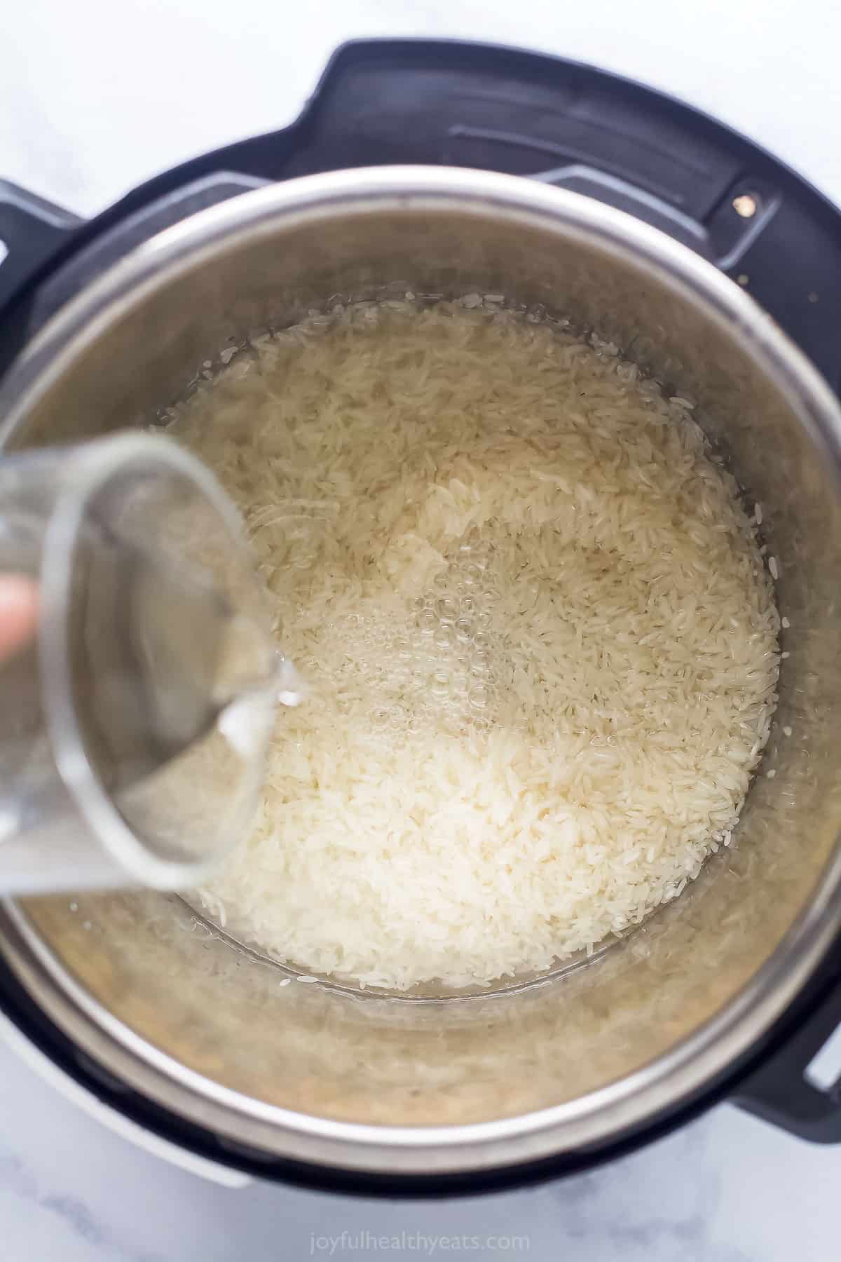 pouring water into a pot with rice