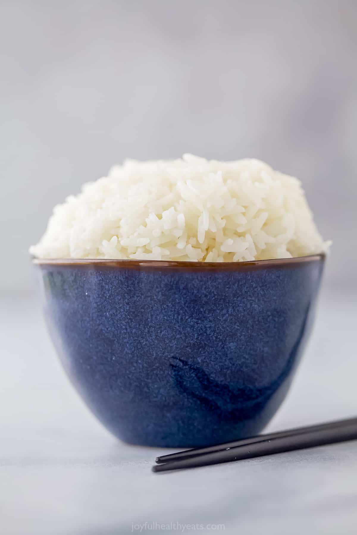 a small blue bowl with cooked white rice