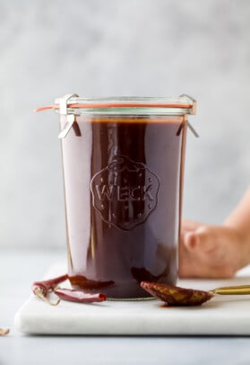 glass jar with red enchilada sauce