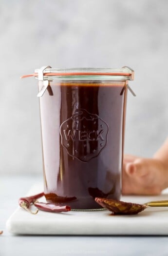 glass jar with red enchilada sauce