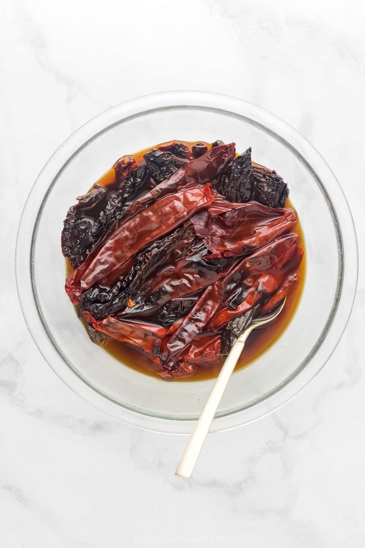 dried chilis soaking in liquid