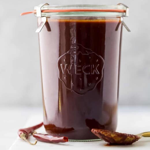 glass jar with red enchilada sauce