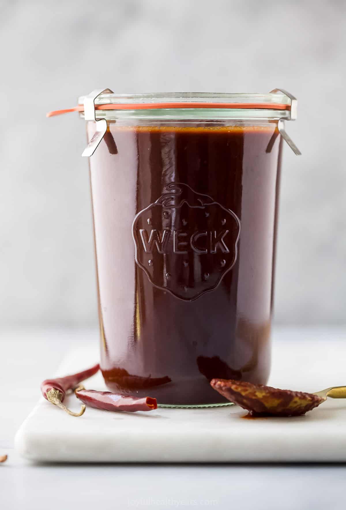 glass jar with red enchilada sauce