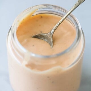a mason jar with boom boom sauce which is a mayonnaise-based sauce that's sweet, spicy, and tangy.