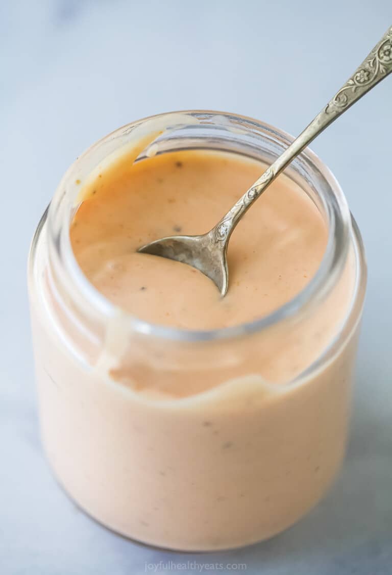 a mason jar with boom boom sauce which is a mayonnaise-based sauce that's sweet, spicy, and tangy.