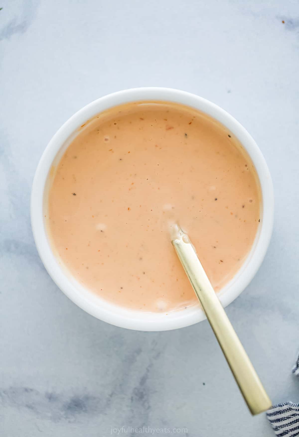 Here's how to make Boom Boom Sauce right at home. This super easy sauce is made with mayo, chili sauce, ketchup, and sriracha. top view of a small bowl with dipping sauce