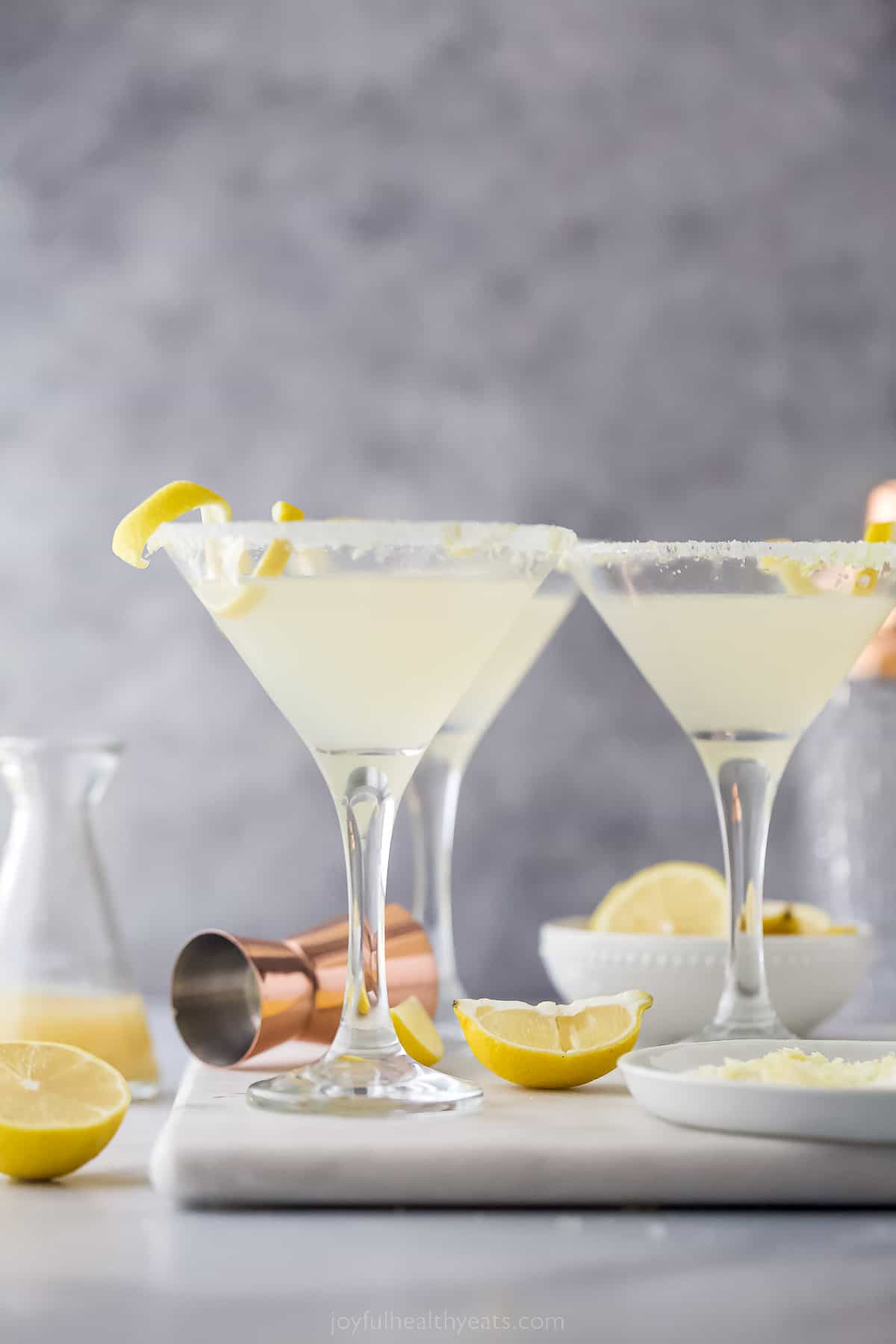 three martini glasses with a pale yellow cocktail