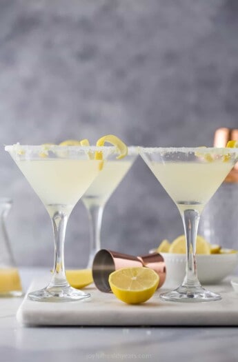 three martini glasses with a pale yellow cocktail