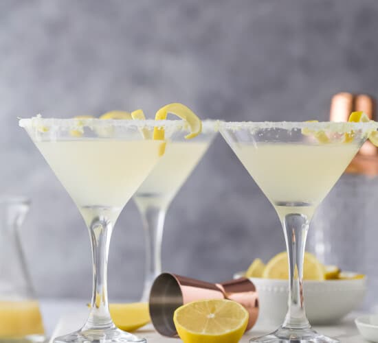 three martini glasses with a pale yellow cocktail