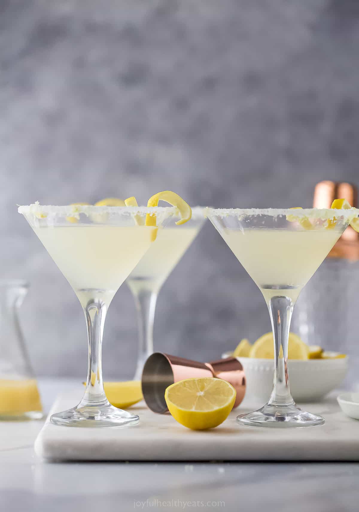 three martini glasses with a pale yellow cocktail