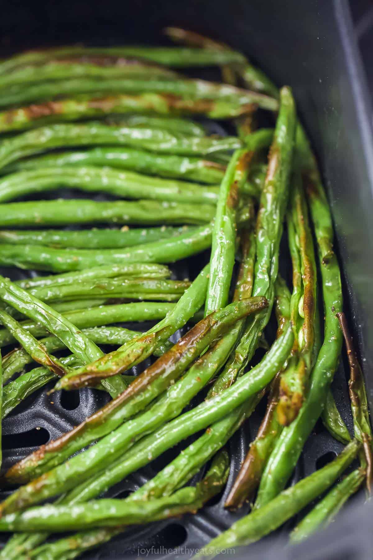 crispy green beans in an air fryer tray