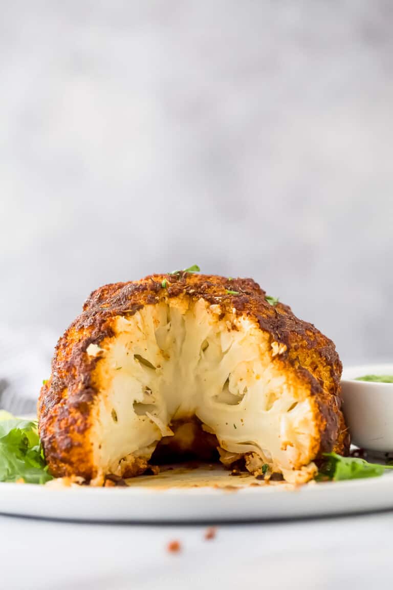 a head of cauliflower that has been roasted with a slice taken out