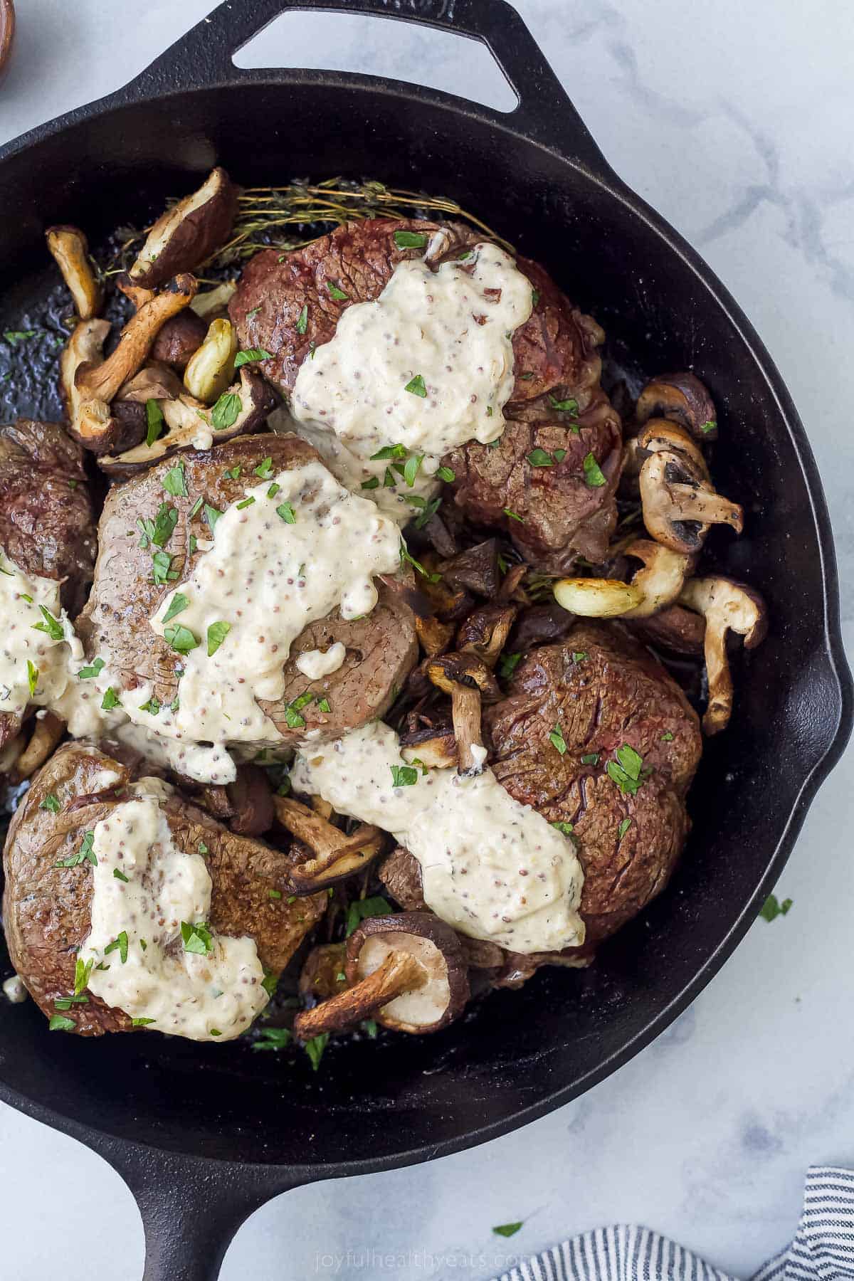 five filet mignon steaks with mushrooms and mustard sauce