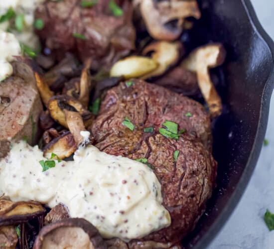 five filet mignon steaks with mushrooms and mustard sauce