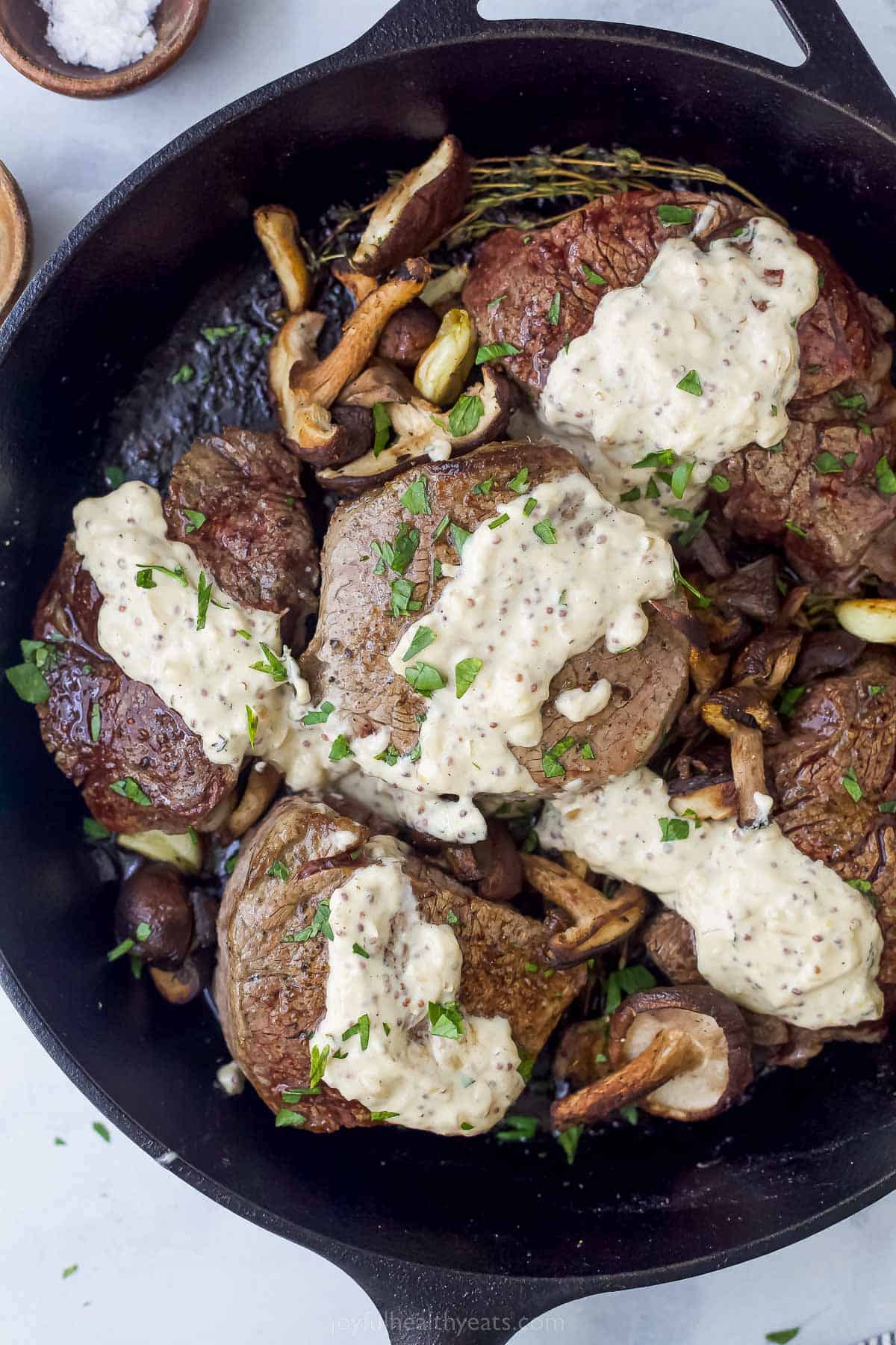 five filet mignon steaks with mushrooms and mustard sauce