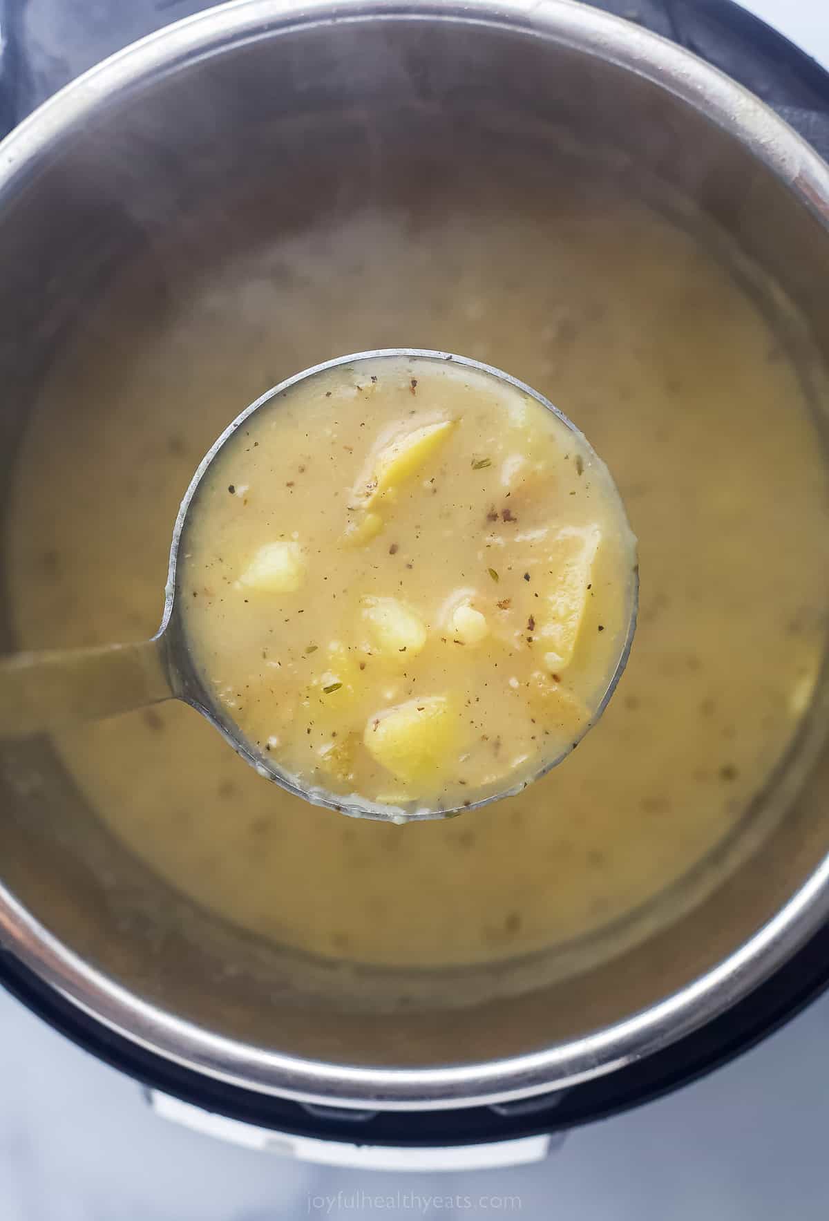 a ladle of potato soup over the Instant Pot that has the remaining soup