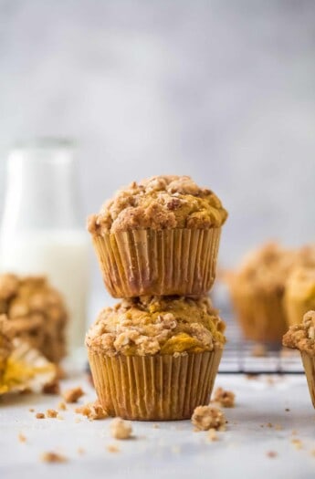 two pumpkin muffins stacked on top of each other