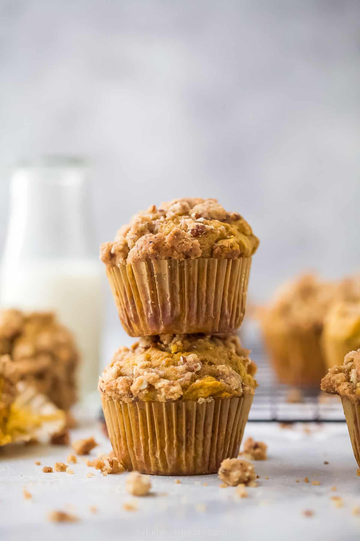 two pumpkin muffins stacked on top of each other