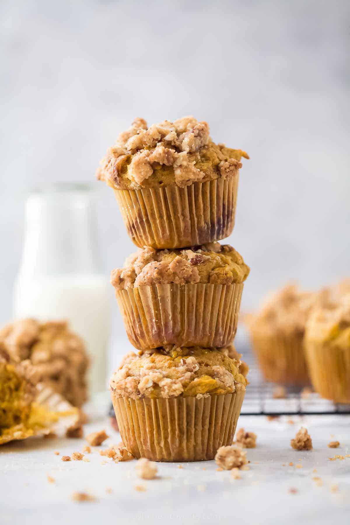 three pumpkin muffins stacked on top of each other