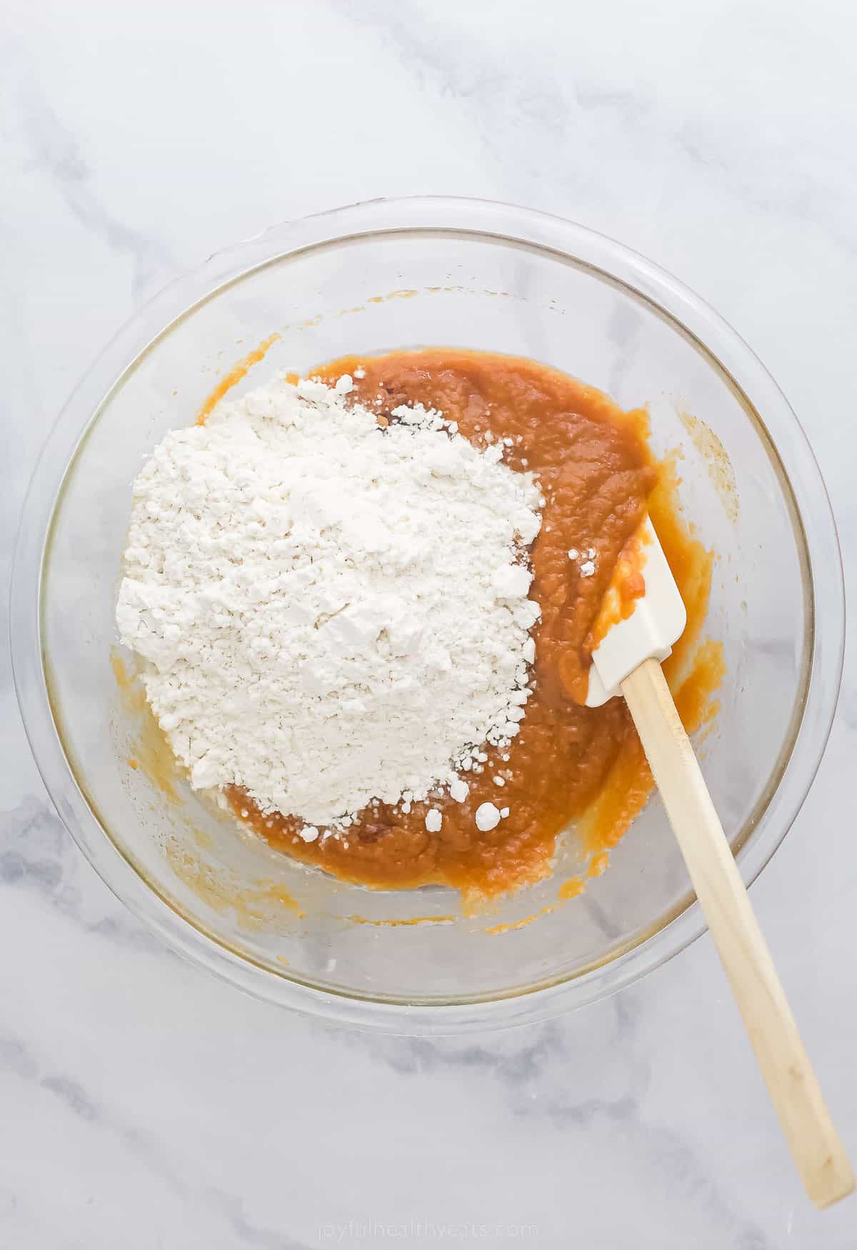 ingredients for pumpkin muffins in a bowl