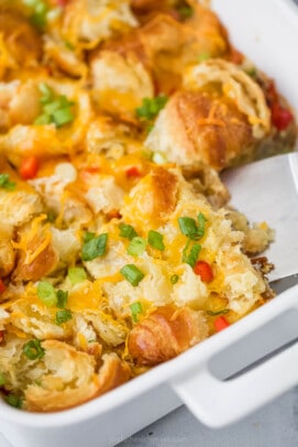 casserole dish with eggs, croissants, peppers, sausage and cheese