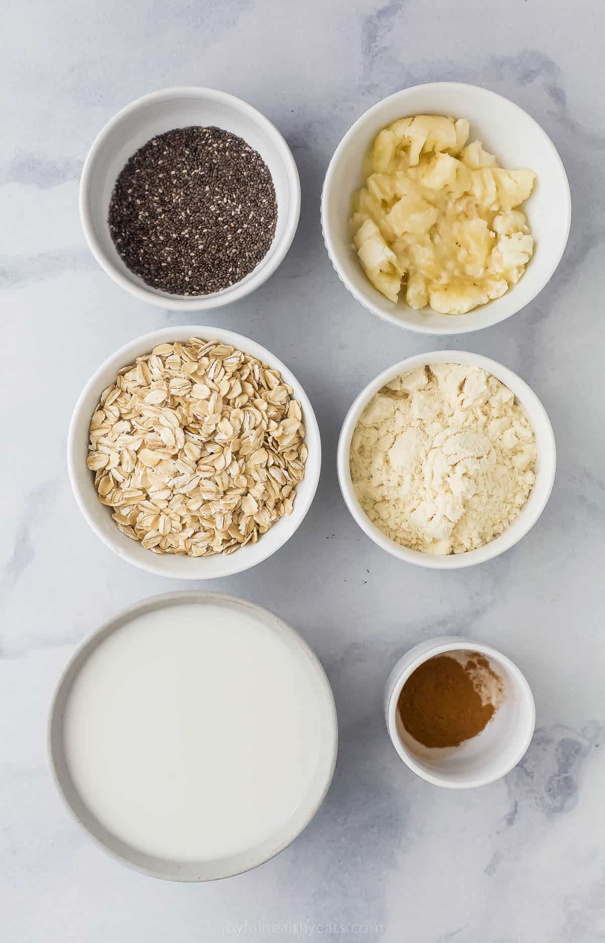 ingredients to make protein overnight oats like milk, cinnamon, steel-cut oats, chia seeds, mashed banana and vanilla protein powder