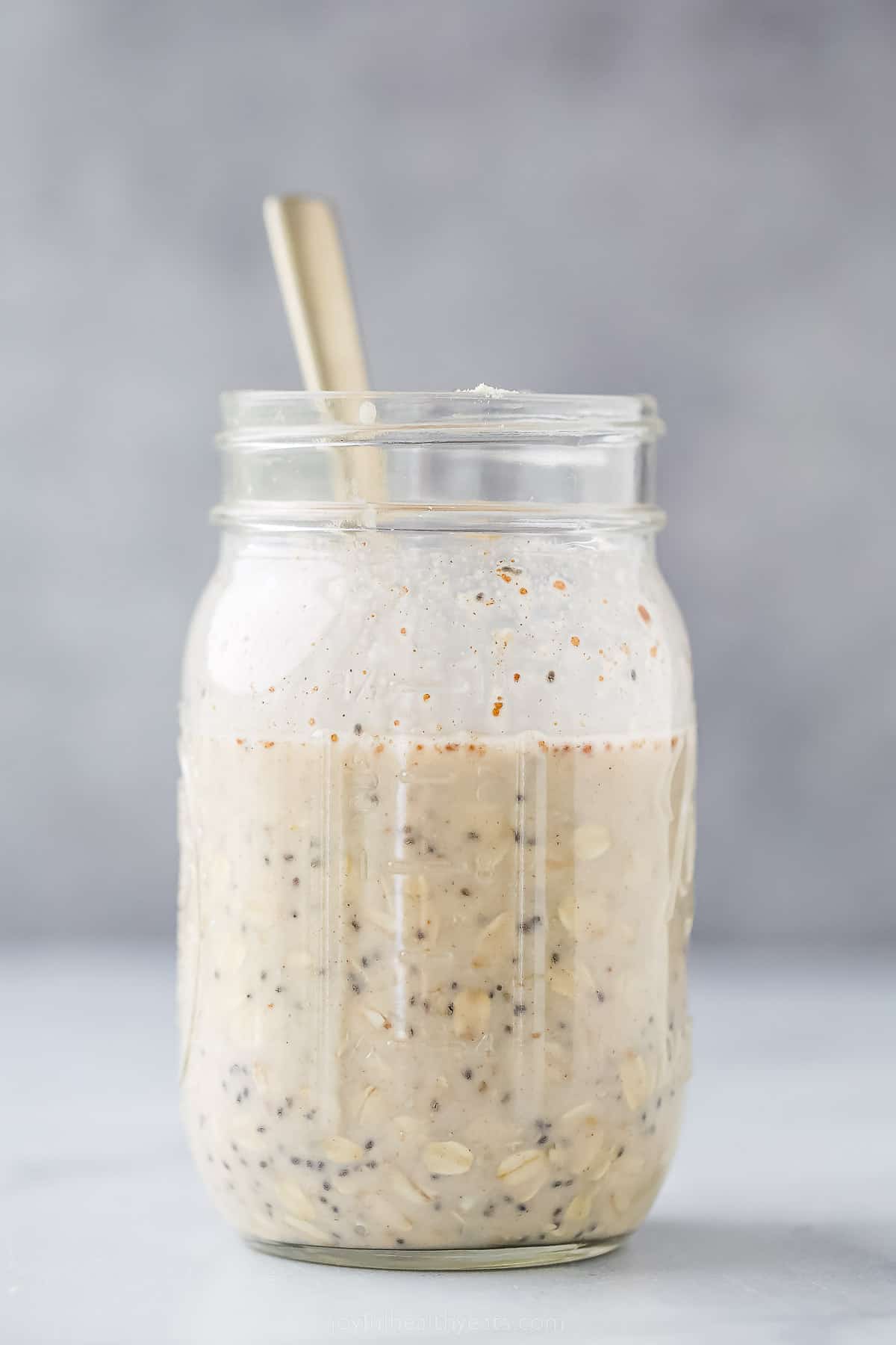 a large mason jar with oats and milk with a s،