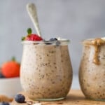 a jar with cooked oats and a strawberry garnish