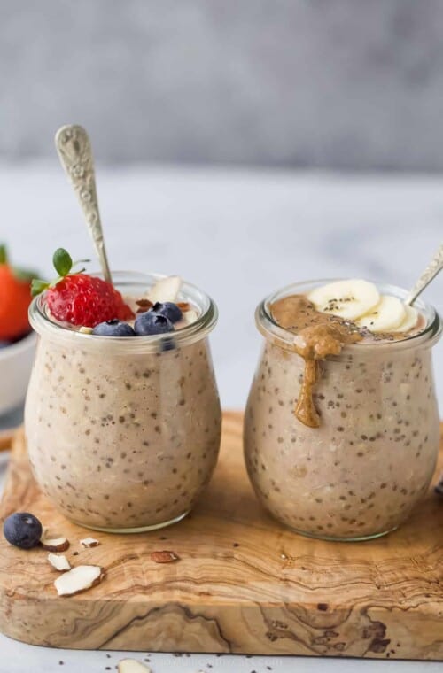 two jars with protein overnight oats and berry and banana garnish