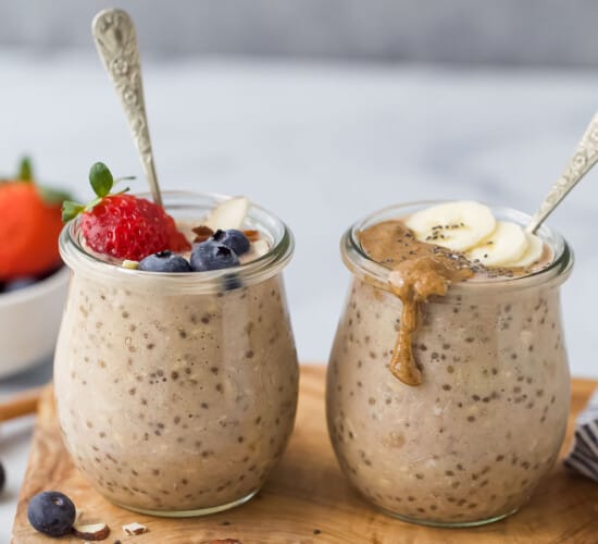 two jars with protein overnight oats and berry and banana garnish
