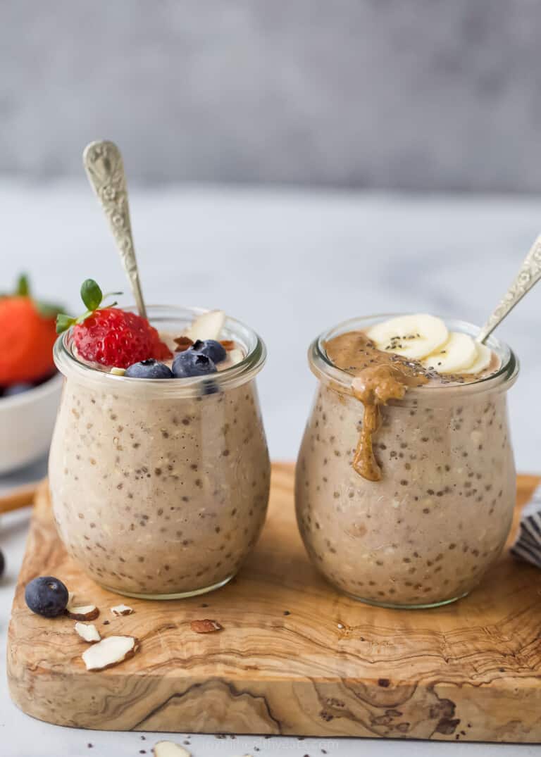 two jars with banana protein overnight oats on a wooden cutting board 