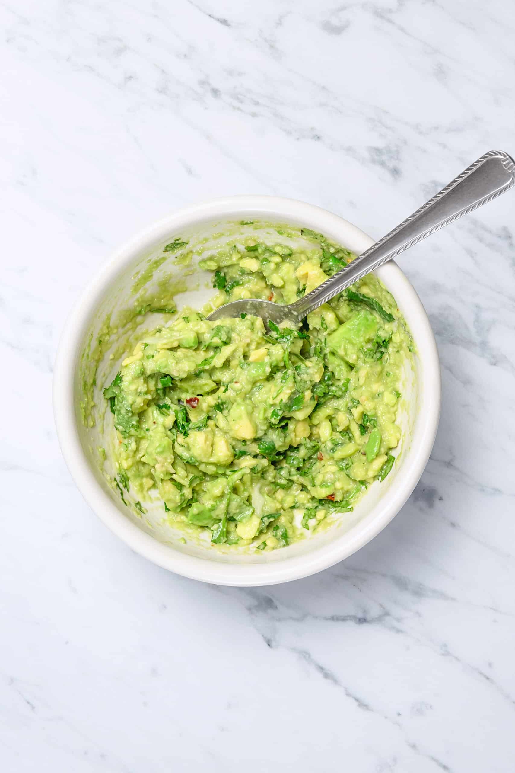 Mashed avocados in a bowl.