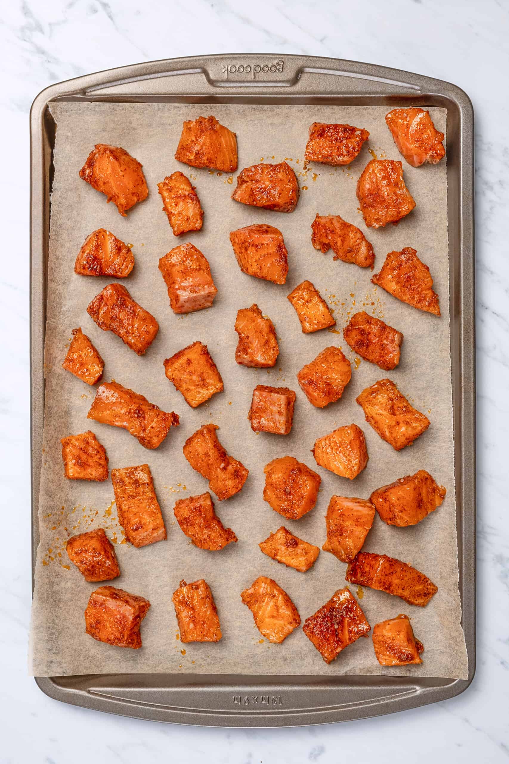 pieces of salmon on a sheet tray