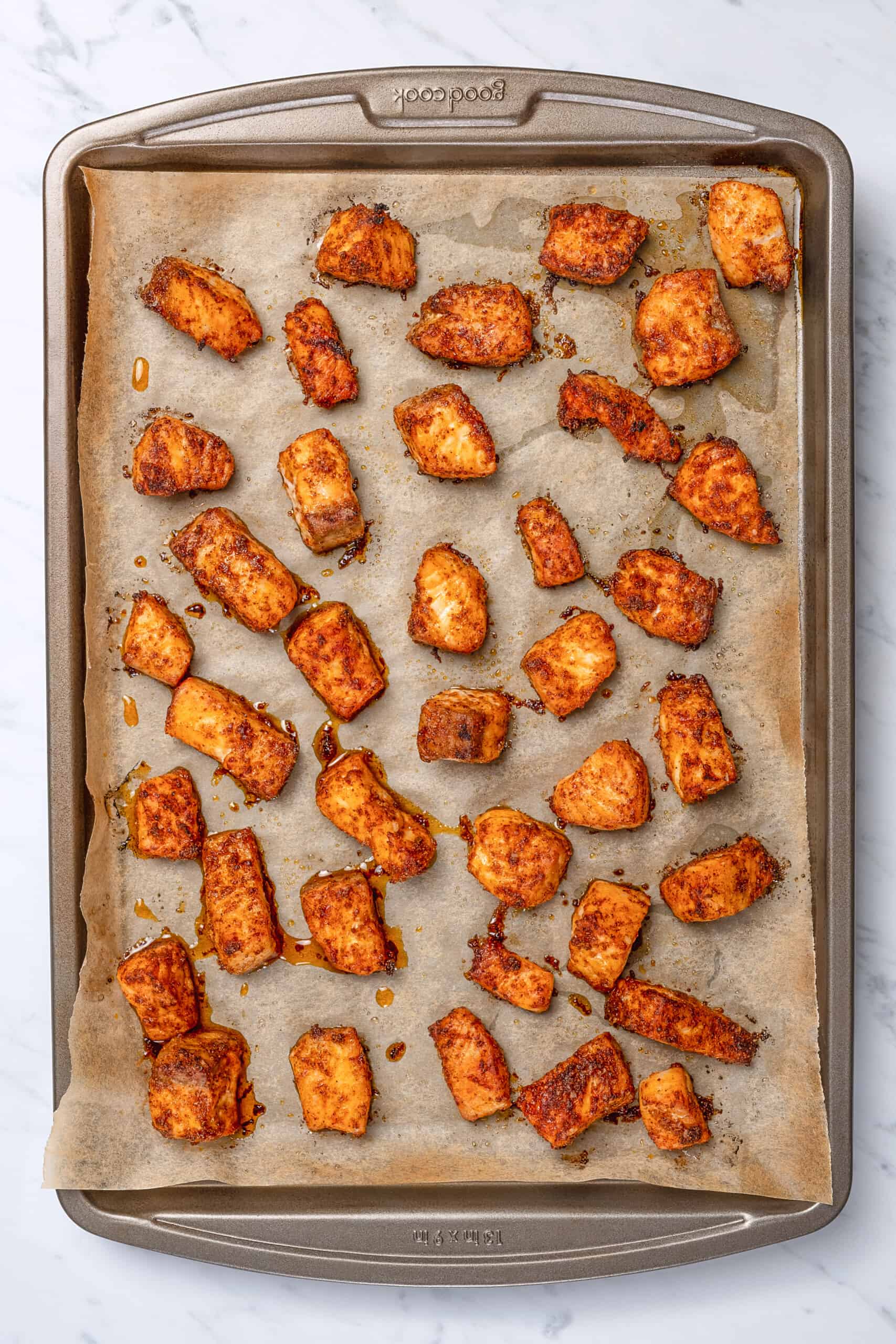 pieces of cooked salmon on a sheet tray