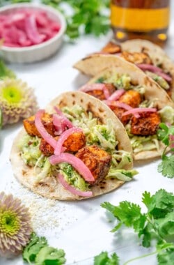easy salmon tacos with creamy sauce and red onion garnish