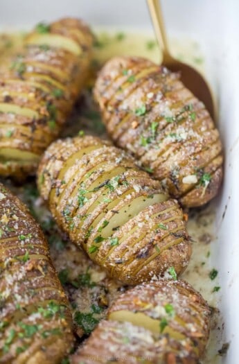 garlic herb hasselback potatoes in a baking dish