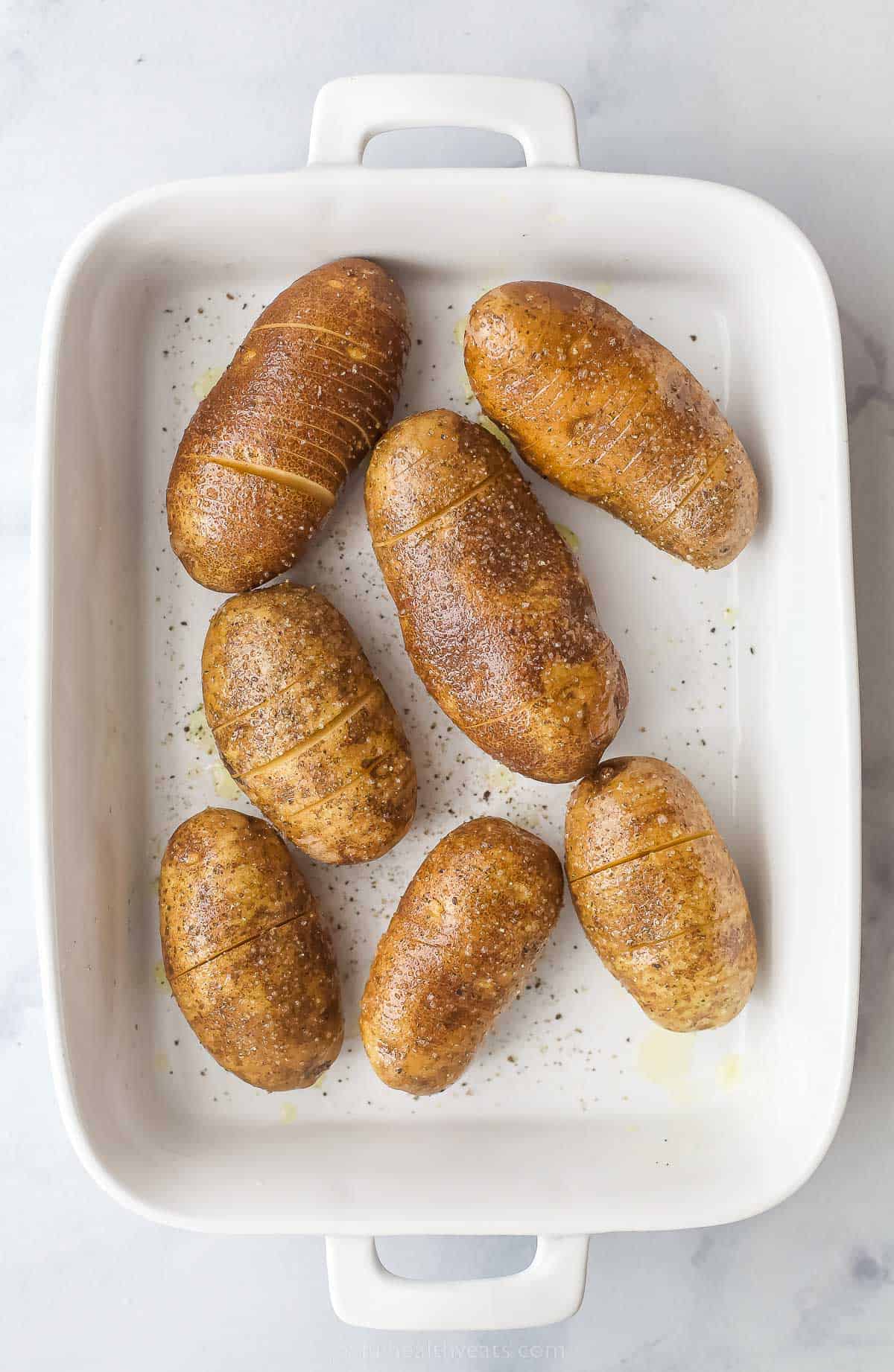 a baking dish with potatoes that have very thin slices in them