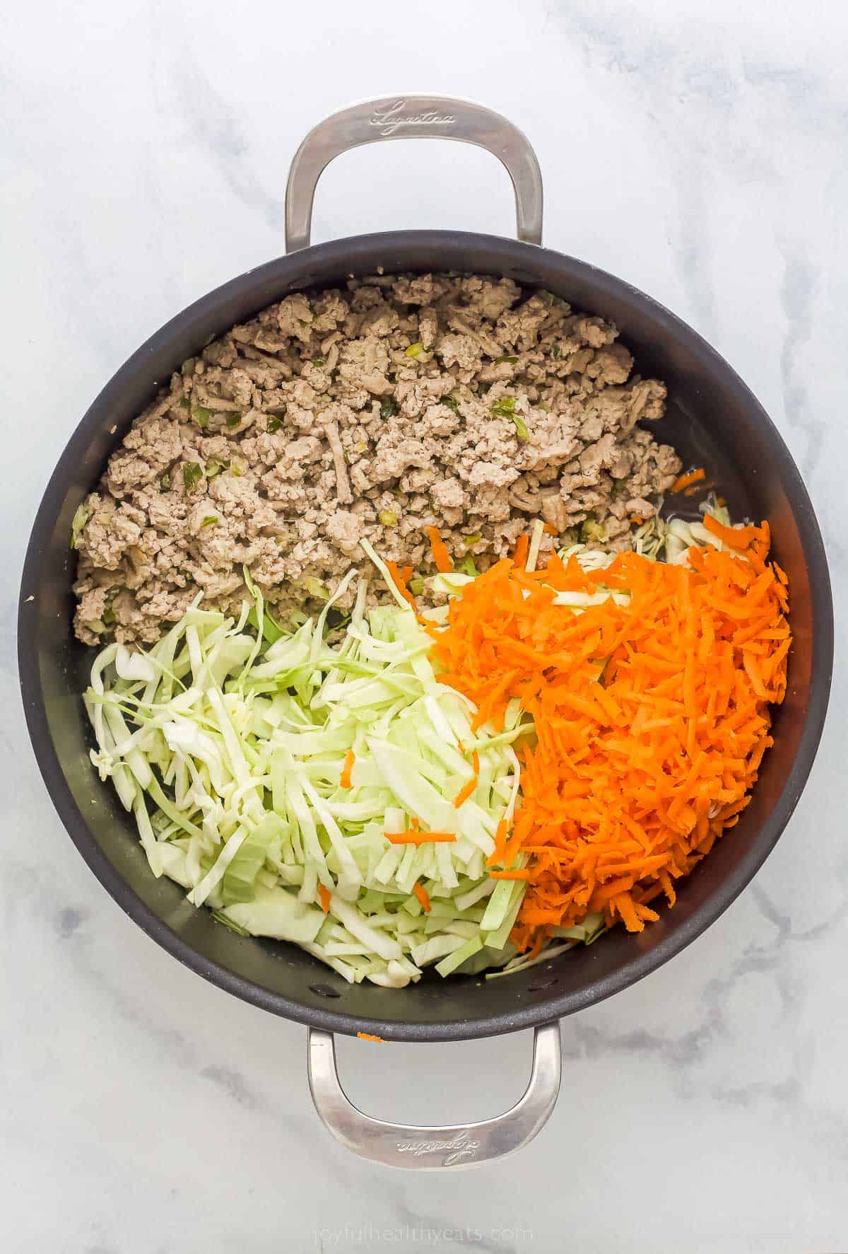 cooked ground turkey, cabbage, and carrots in a pan