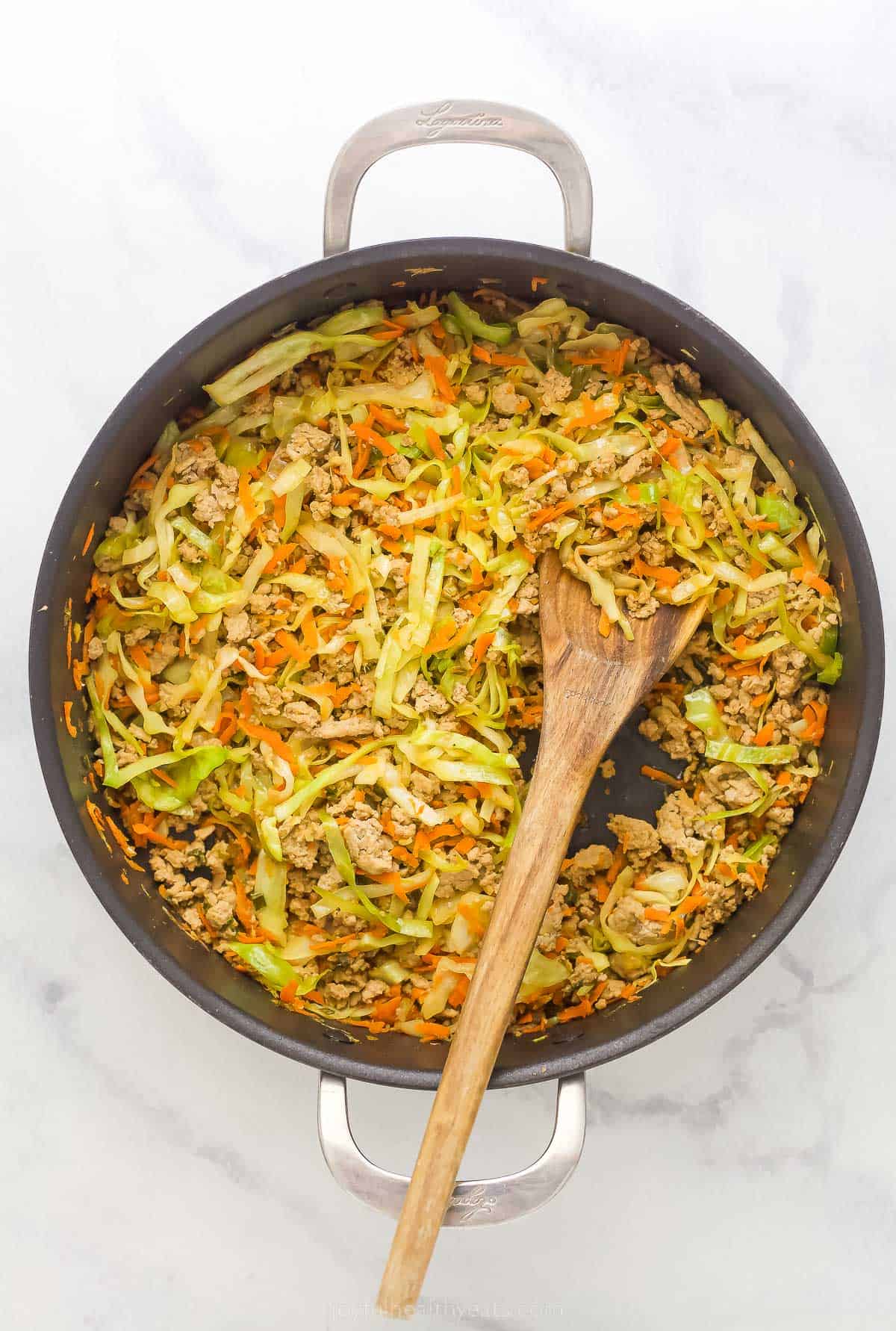 egg roll in a bowl ingredients in a pan like ground turkey, cabbage, and carrots