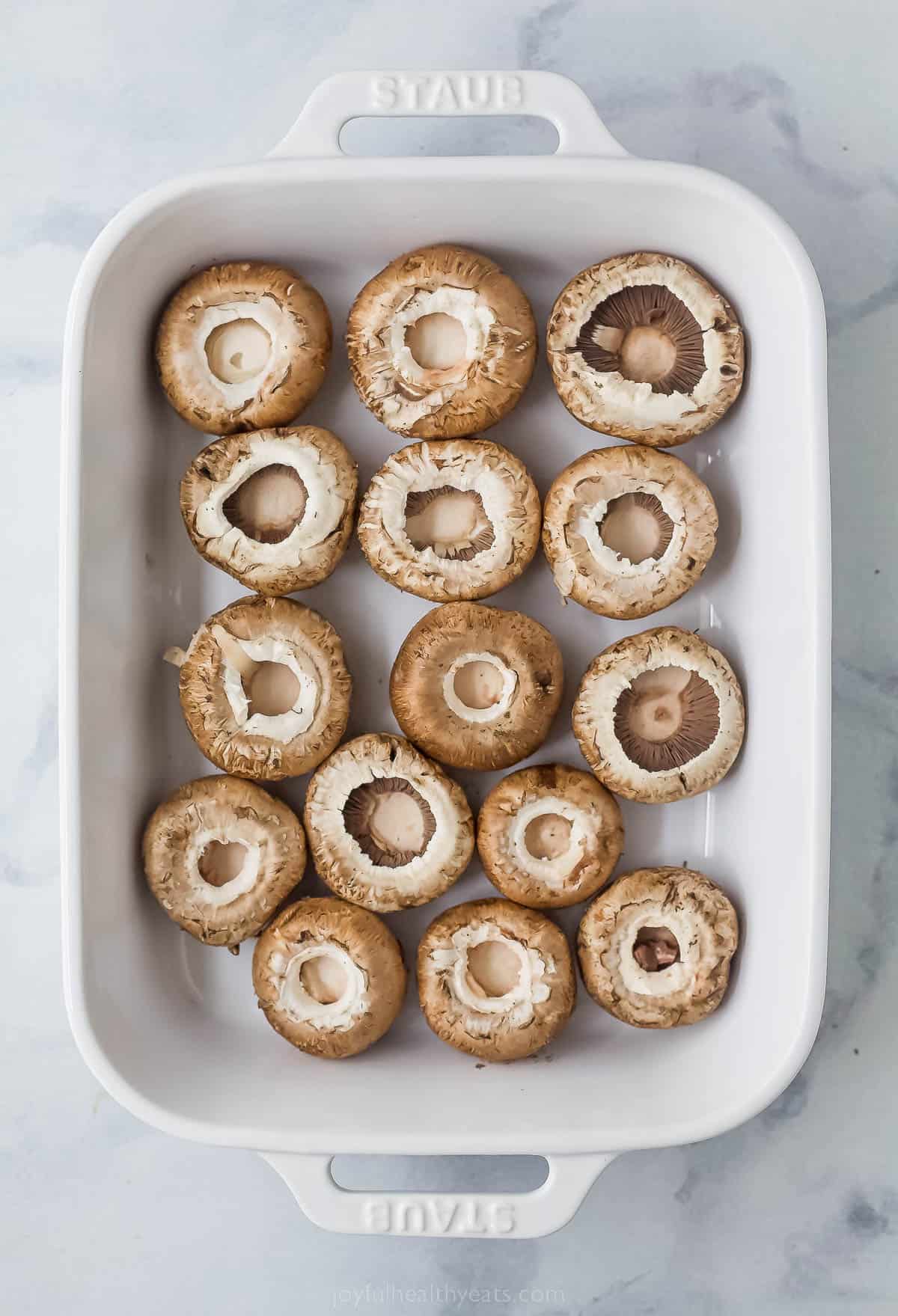 mushrooms laying flat in a casserole dish