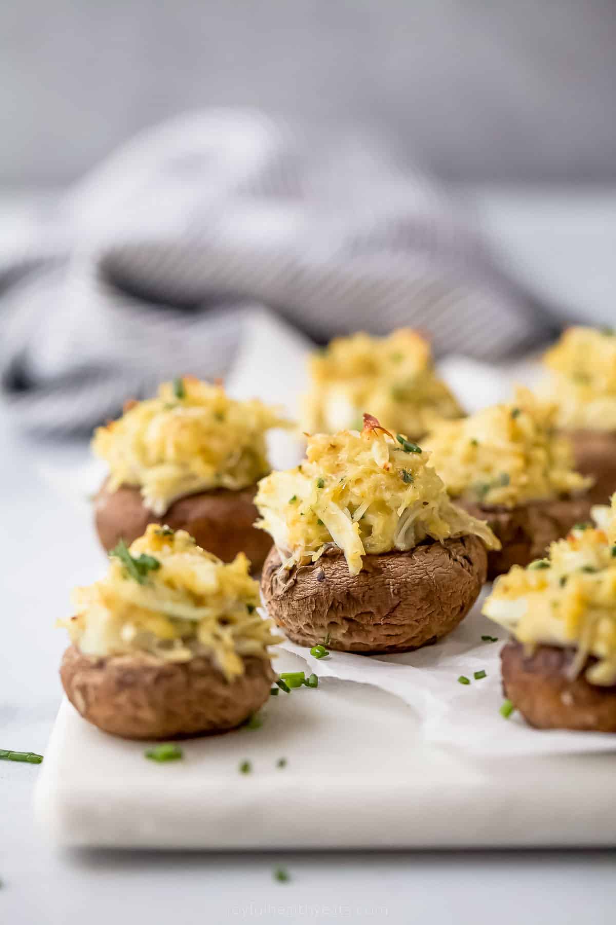 crab stuffed mushrooms with parmesan cheese on top