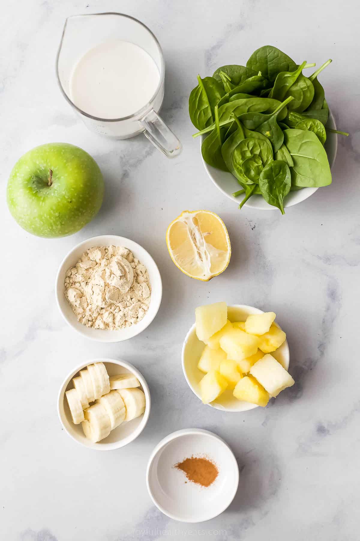 This Slimming Detox Smoothie is the perfect green smoothie! It has spinach, apples, pineapple, and banana, plus a dash of cinnamon! small bowls with protein powder, pineapple, banana, protein powder, and spinach
