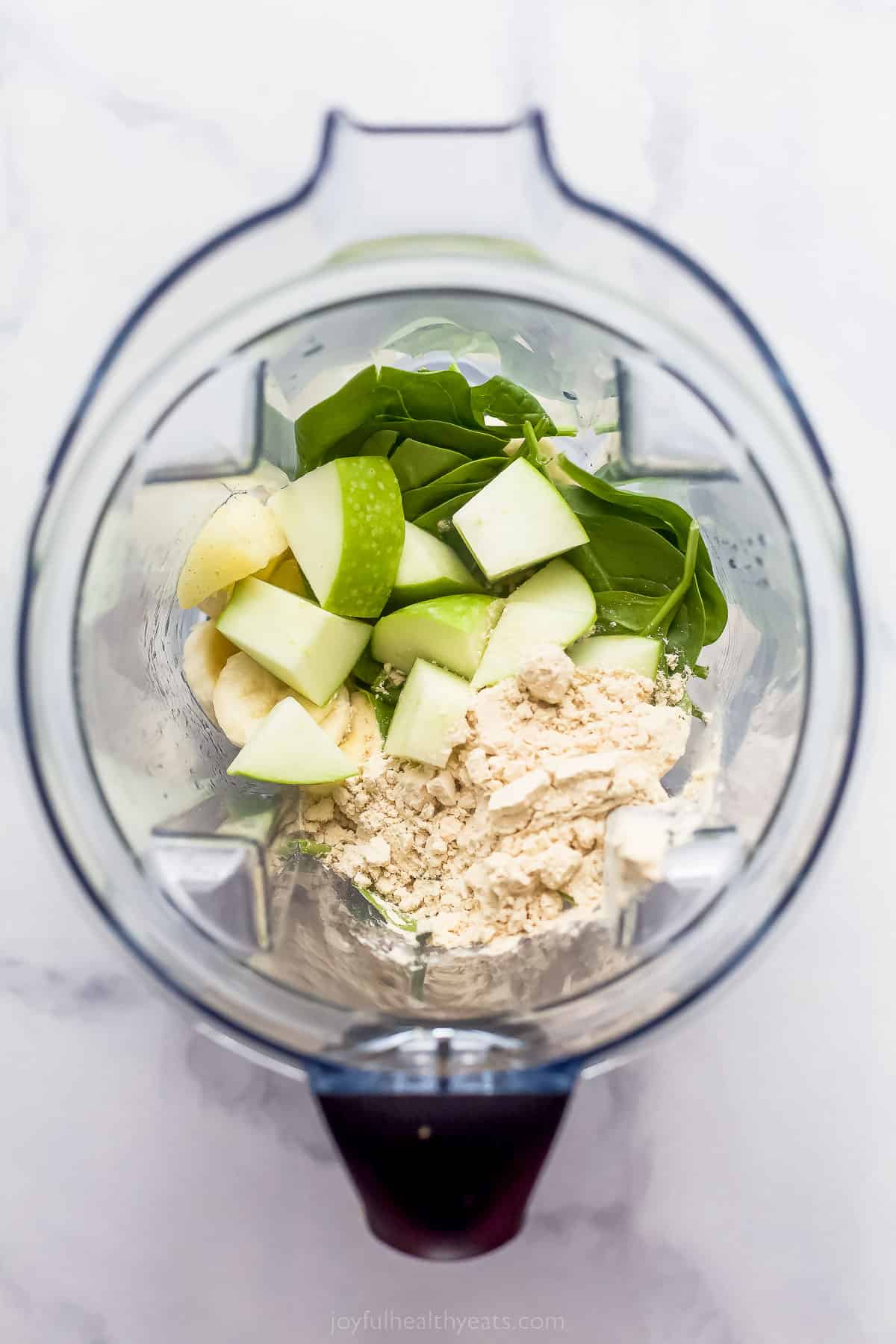 This Slimming Detox Smoothie is the perfect green smoothie! It has spinach, apples, pineapple, and banana, plus a dash of cinnamon! diced apples, spinach, and protein powder in a blender