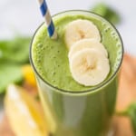 top view of a green smoothie with banana slices as garnish