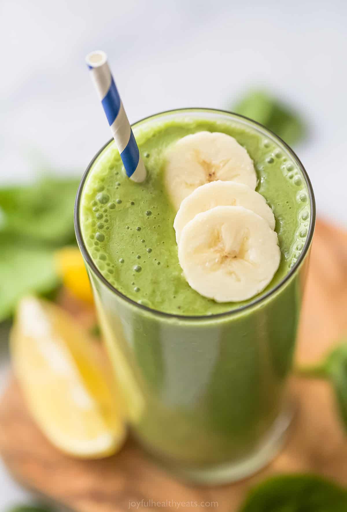 top view of a green smoothie with banana slices as garnish