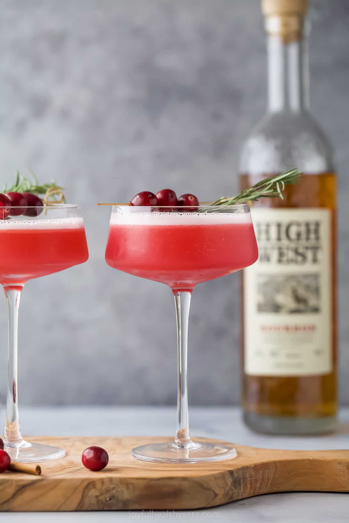 Spiced Cranberry Whiskey Sour in a coupe gl، and garnished