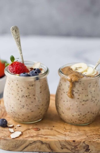 two jars with protein overnight oats and berry and banana garnish