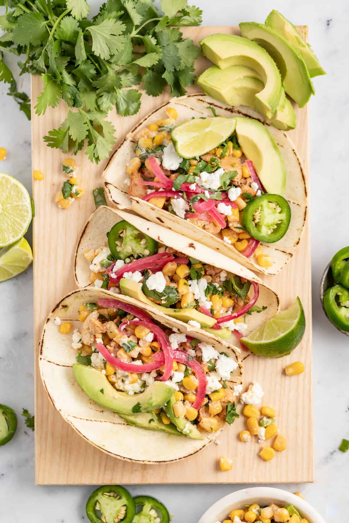 a display of chicken tacos on a board