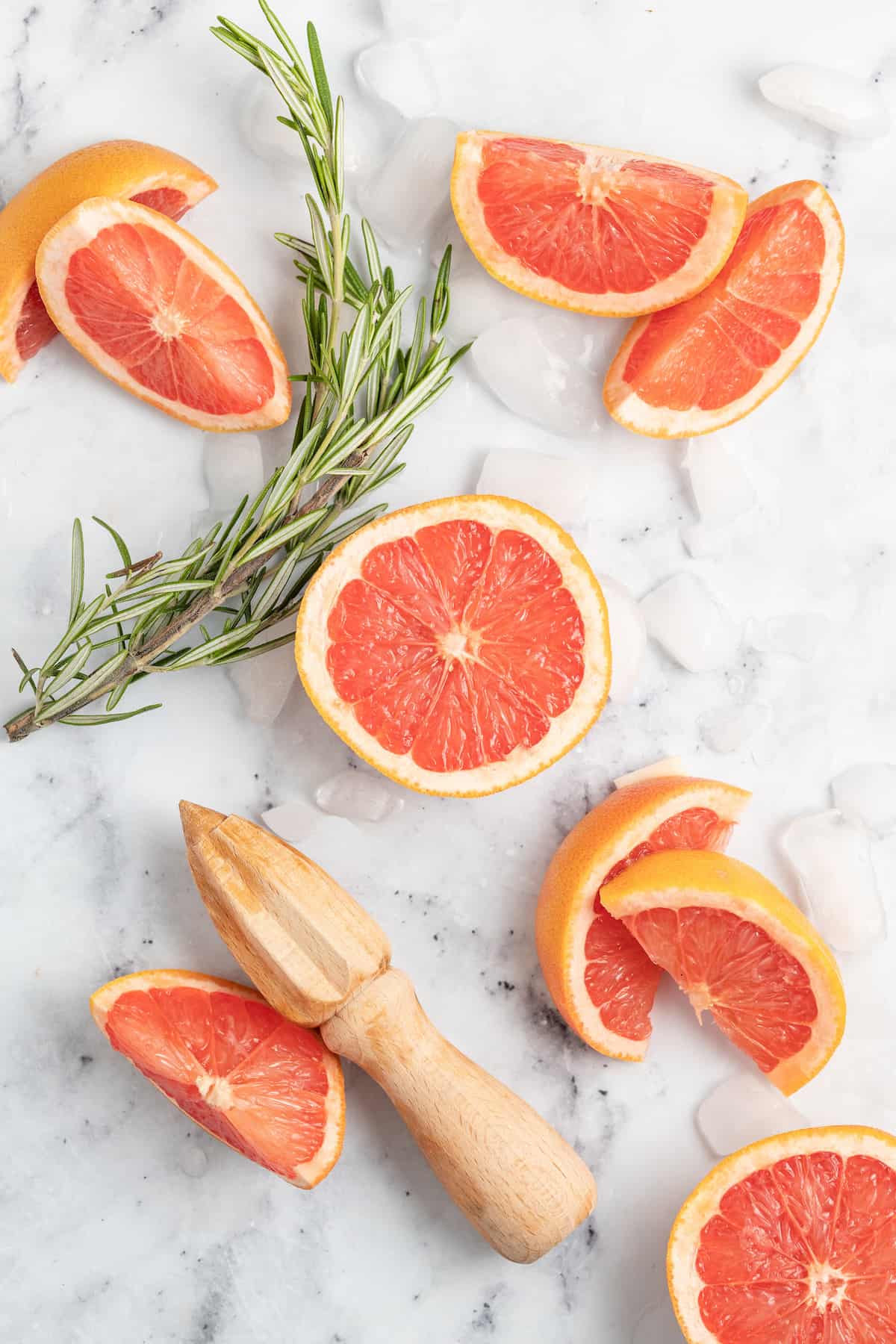 cut up grapefruits with a juicer on a cutting board